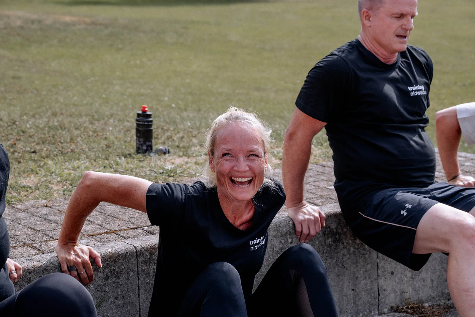Fabienne laughing during an exercise on the wall, another participant next to her