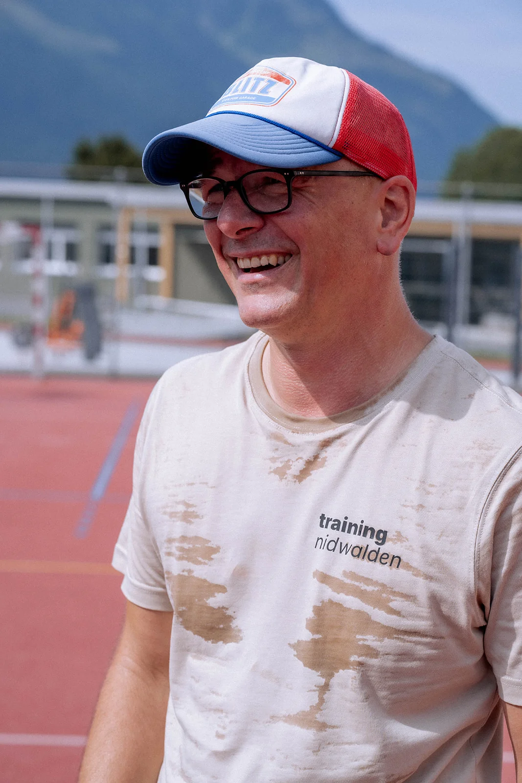 Franco wearing a cap and laughing after the session on the sports ground