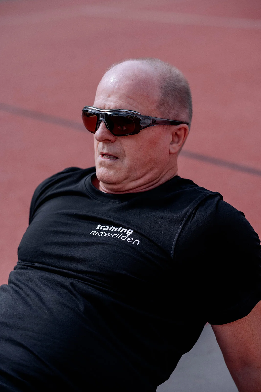 Hans wearing sunglasses during an exercise on the running track